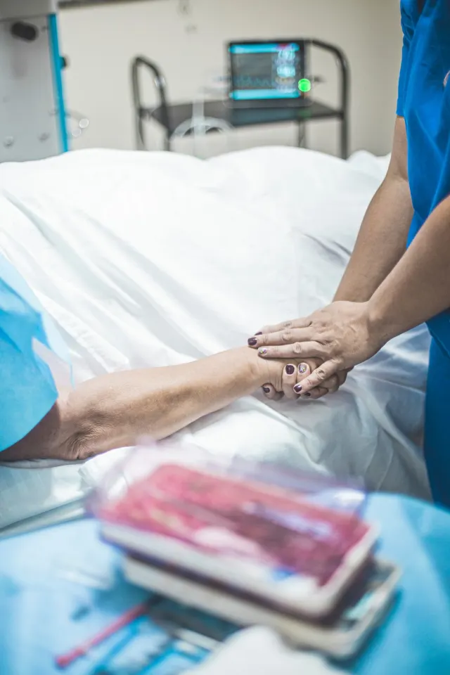 Nurse comforting a bedridden patient