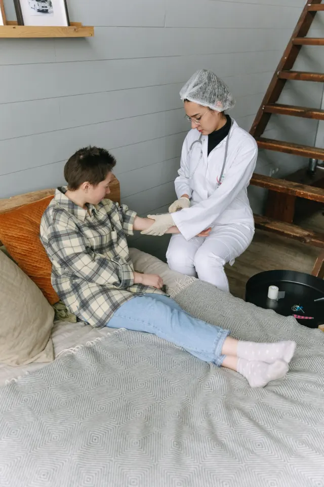 Healthcare worker assisting a patient at home